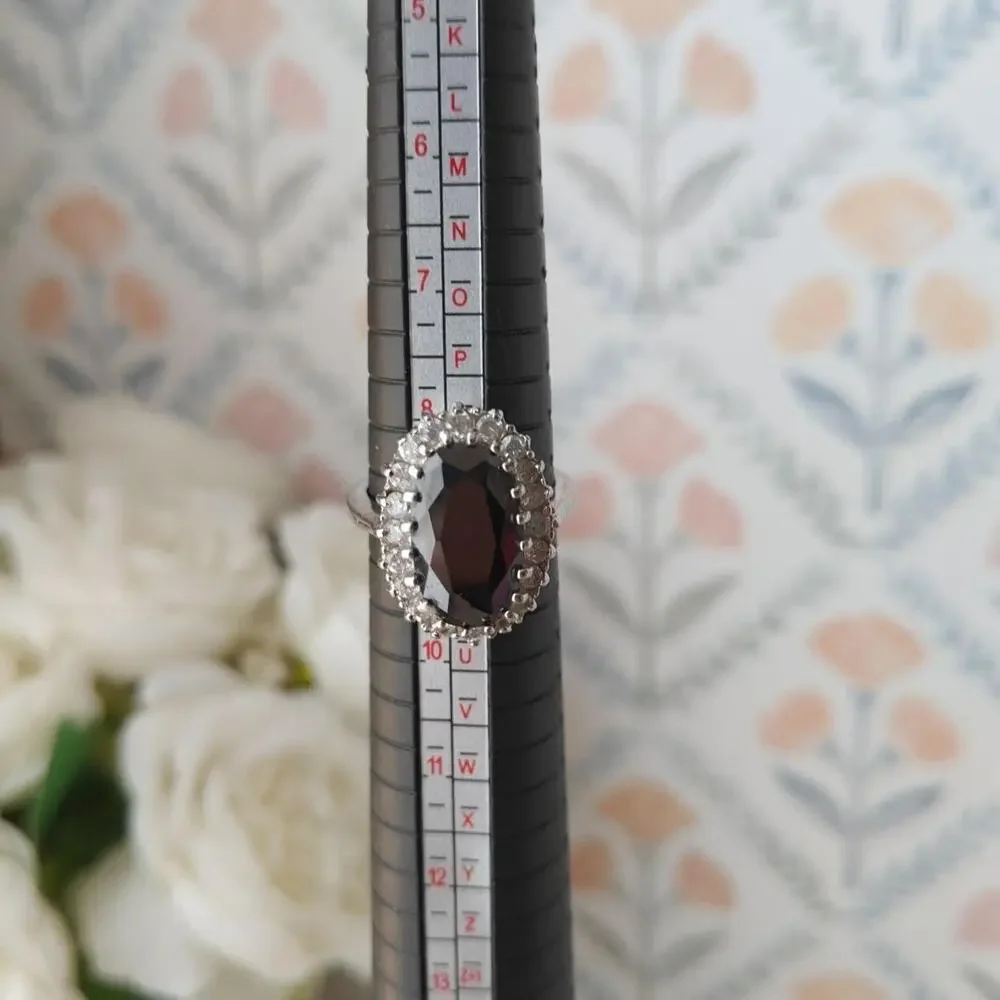 Silver tone oval black glass halo ring with white rhinestones